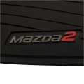 Srebrno-czerwone logo Mazda 2 na dywanikach gumowych do Mazdy 2 DJ.